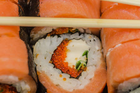 Sushi is a classic Japanese snack made from finely chopped fish fillets, usually raw, less smoked, vegetables, seafood, appropriately boiled rice, sometimes wrapped in algae noriaの写真素材