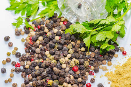 Fragrant black pepper on a white background, this is a common spice with useful properties