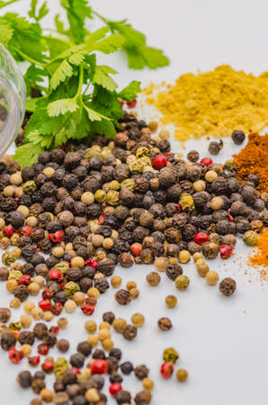 Fragrant black pepper on a white background, this is a common spice with useful propertiesの写真素材