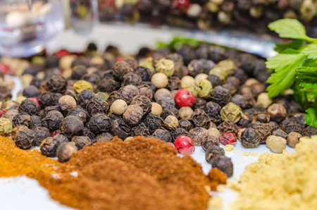 Fragrant black pepper on a white background, this is a common spice with useful propertiesの写真素材
