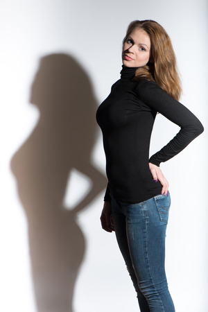 Portrait of young beautiful woman close up on white background with shadowの写真素材