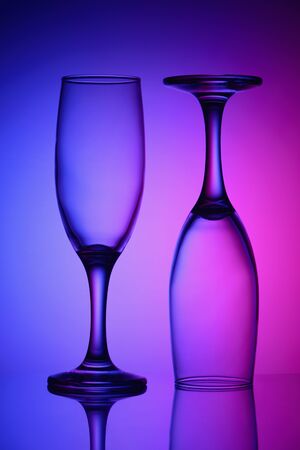 Two empty glasses in bicolor lightの写真素材