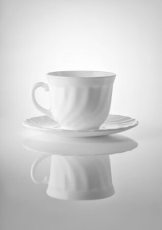 Cups for tea with saucers on a white backgroundの写真素材
