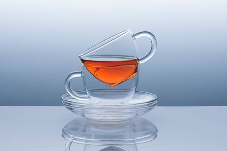 Two cups with saucers from transparent glass from the tea remainsの写真素材