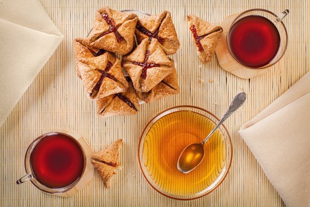 Two cups of black tea, shortcake with jam and honeyの写真素材