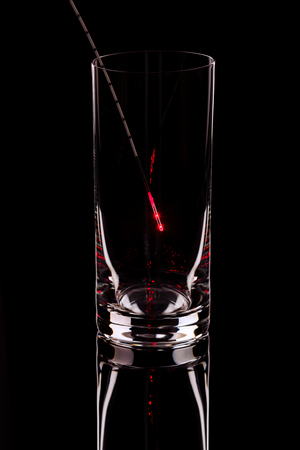The shining probe in an empty glass on a black backgroundの写真素材