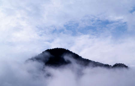 Mountain growth from low clouds.  Bad weather for trekking.の写真素材