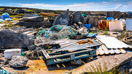Accumulation of garbage such as wooden pallet, rusty metal sheets, fishing ropes, rusty fridges and...