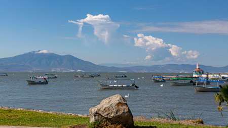 Chapala, Jalisco / Mexico, January 20th, 2020. Chapala lake with motor boats and pelicans on the calm waters with mountains in the background, sunny day in the state of Jalisco, Mexicoのeditorial素材