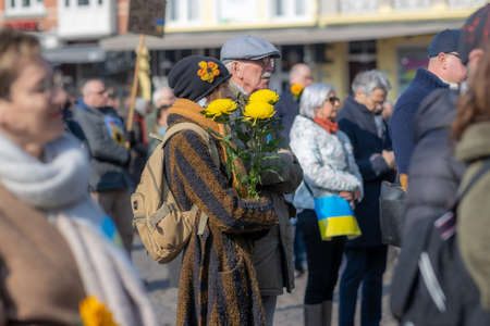 Roermond, Limburg, Netherlands. March 6, 2022. Protest against Russian armed invasion of Ukraine. Group of people peacefully demonstrating. Concept of pacifism and prayer for peace in the worldのeditorial素材
