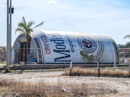 Jalisco Mexico. December 19, 2009. Original design of store in a huge can of Modelo brand beer against blue sky, selling alcohol and groceries, middle of desolate dry and arid land, next to rural roadのeditorial素材