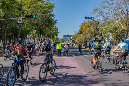 Guadalajara, Jalisco Mexico. January 8, 2023. People riding bicycles, running along Avenue, Glorieta Minerva in background, urban landscape, street closed for sports, weekend recreational routeのeditorial素材