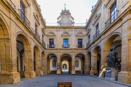 Seville, Spain. January 17, 2015. Inner courtyard of former Royal Tobacco Factory, today headquarters of University of Seville, Renaissance building, corridors between portals, arches and pillarsのeditorial素材