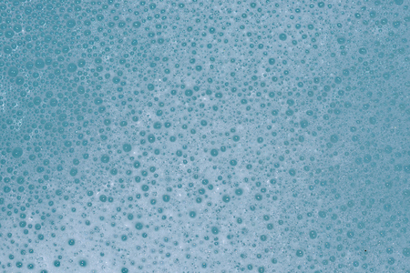 beautiful foam on the water surface  small bubbles on blue waterの写真素材