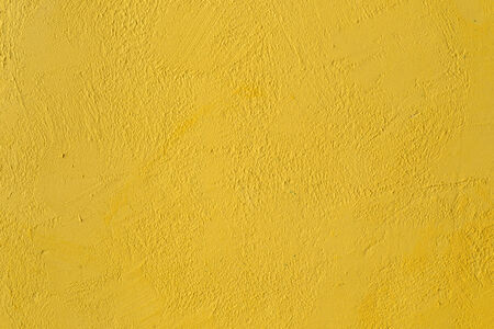 fragment of the  yellow wall with decorative plasterの写真素材