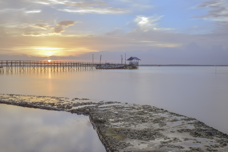 Bridge of a pier in the sunset  momentの写真素材