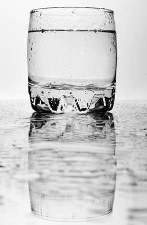 Glass of water with drops.の写真素材