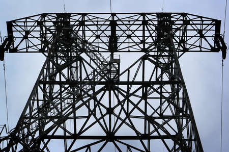 High voltage tower on sky background.