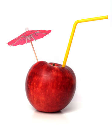 Apple with straw and umbrella.の写真素材