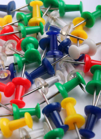 Colorful pins on white background.