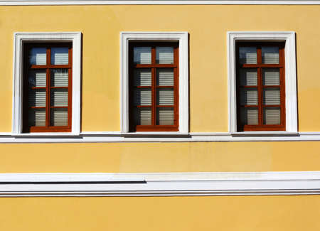 Three windows in yellow wall