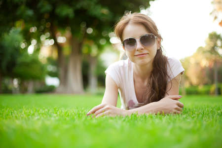 Beautiful young woman on the grassの写真素材