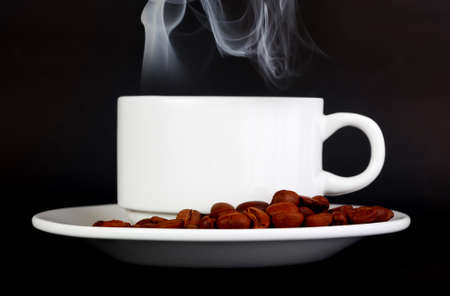 Cup of coffee beans isolated on blackの写真素材