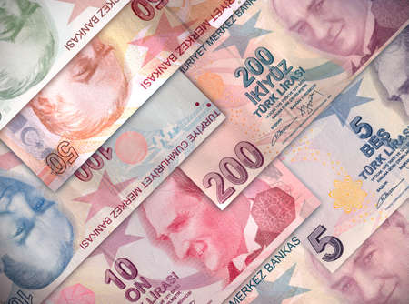 Different money bills stacked over each other forming a money background.