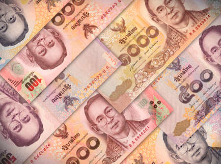 Different money bills stacked over each other forming a money background.の写真素材