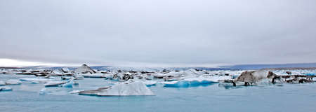 Glacier reaching the sea breaking up into small pieces of ice