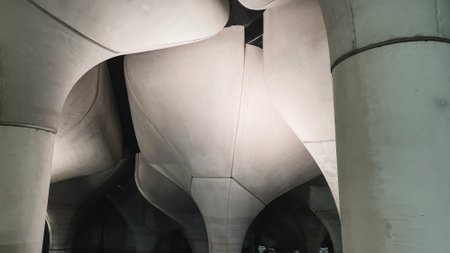 Abstract concrete columns with smooth curves and geometric patterns, showcasing modern architectural design and lighting.の写真素材
