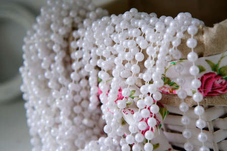 Still life of wicker basket and beads. The concept of needlework and goods and objects for creativity.の写真素材