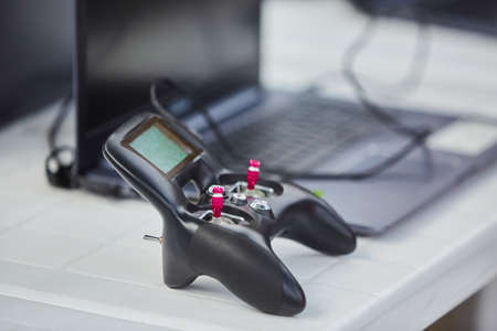 The joystick for computer games lies on the surface of a pure blue color. The concept of gaming, new...