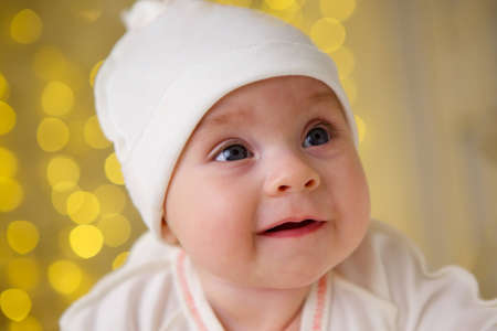 Little newborn baby girl lying in white clothes on white background.の写真素材