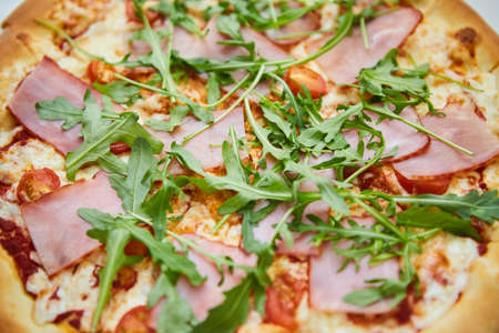 A boring fast food dish pizza. Italian food. Cooking in a restaurant or with your own hands at home.