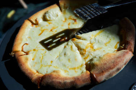 A boring fast food dish pizza. Italian food. Cooking in a restaurant or with your own hands at home.の写真素材