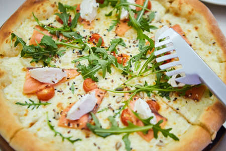 A boring fast food dish pizza. Italian food. Cooking in a restaurant or with your own hands at home.の写真素材