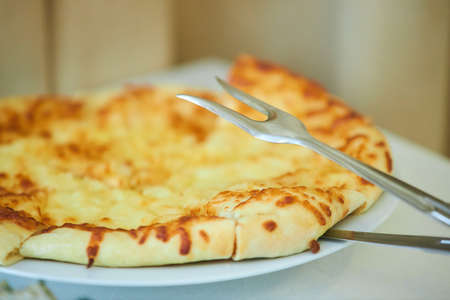 A boring fast food dish pizza. Italian food. Cooking in a restaurant or with your own hands at home.の写真素材