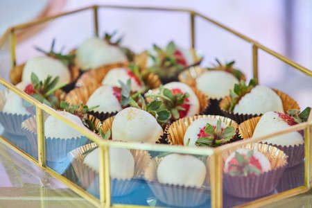 Beautiful and bright desserts on the festive table for the party. Confectionery with cream and marzipan.の写真素材