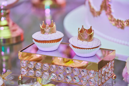 Beautiful and bright desserts on the festive table for the party. Confectionery with cream and marzipan.の写真素材