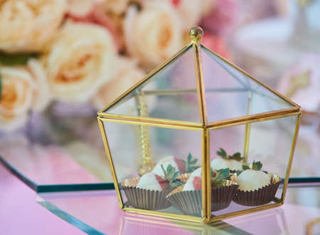 Beautiful and bright desserts on the festive table for the party. Confectionery with cream and marzipan.の写真素材