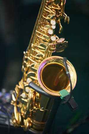 Musical instrument saxophone in the hands of the artist. Concept of a concert, jazz or classical music.の写真素材