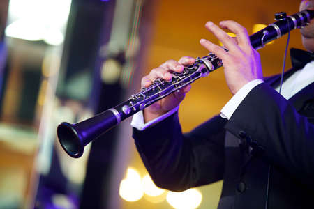 Musical instrument flute in the hands of a male musician. The concept of culture and art.の写真素材