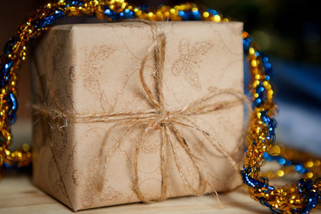 A gift box decorated for Christmas or New year. The concept of festive mood and preparation.