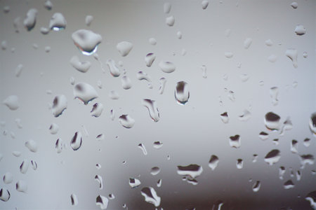 Rain drops or condensation on the glass. It is a cold autumn or winter