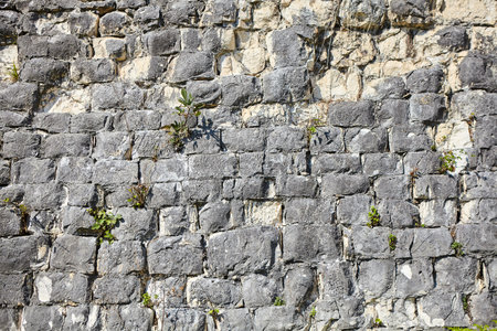Background texture of a stone wall photo. Natural stone wall texture for the background. Old brick texture, grunge background of a brick wall.の写真素材