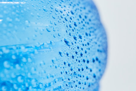 Water drops on the surface of a plastic bottle. The concept of clean ecological drinking water.の写真素材
