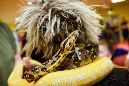 A snake on a man. Exotic animals.