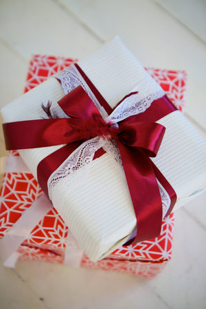 A gift box decorated for Christmas or New year with ribbons.