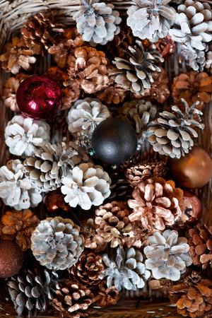 Cones and Christmas toys are in the basket. The concept of a holiday and New Year decorations.